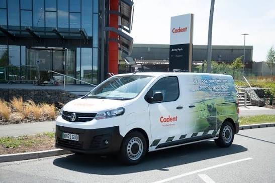 A white Cadent Gas van parked outside a glass-fronted office.