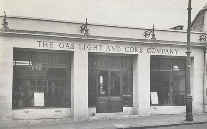 The Gas Light and Coke Company offices in Wembley, a low stone building with the name in large letters above its shop windows.